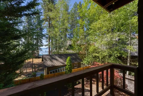 a view of a wooden chairs and table in a balcony