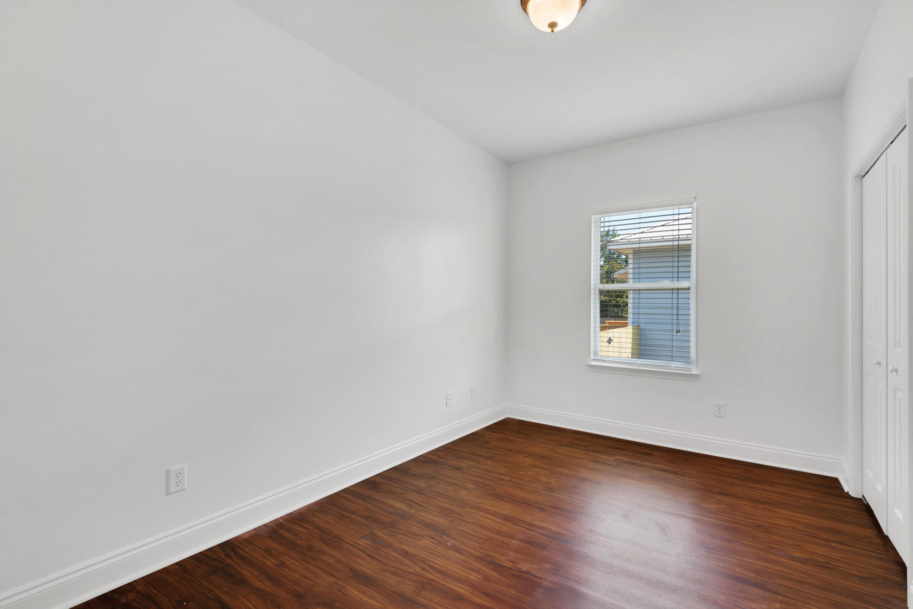 249 County Line Road Niceville, FL 32578 - Photo 15 of 17 an empty room with wooden floor and windows