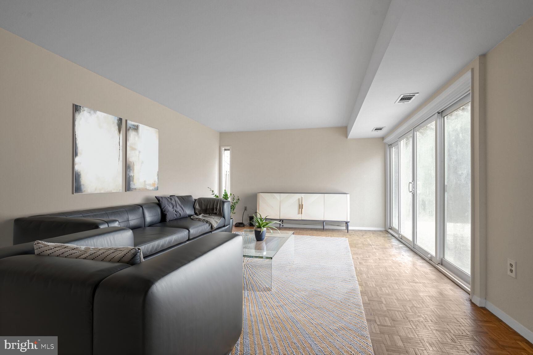 11350 Links Drive Reston, VA 20190 - Photo 6 of 22 a large bedroom with a large bed couch and a large window