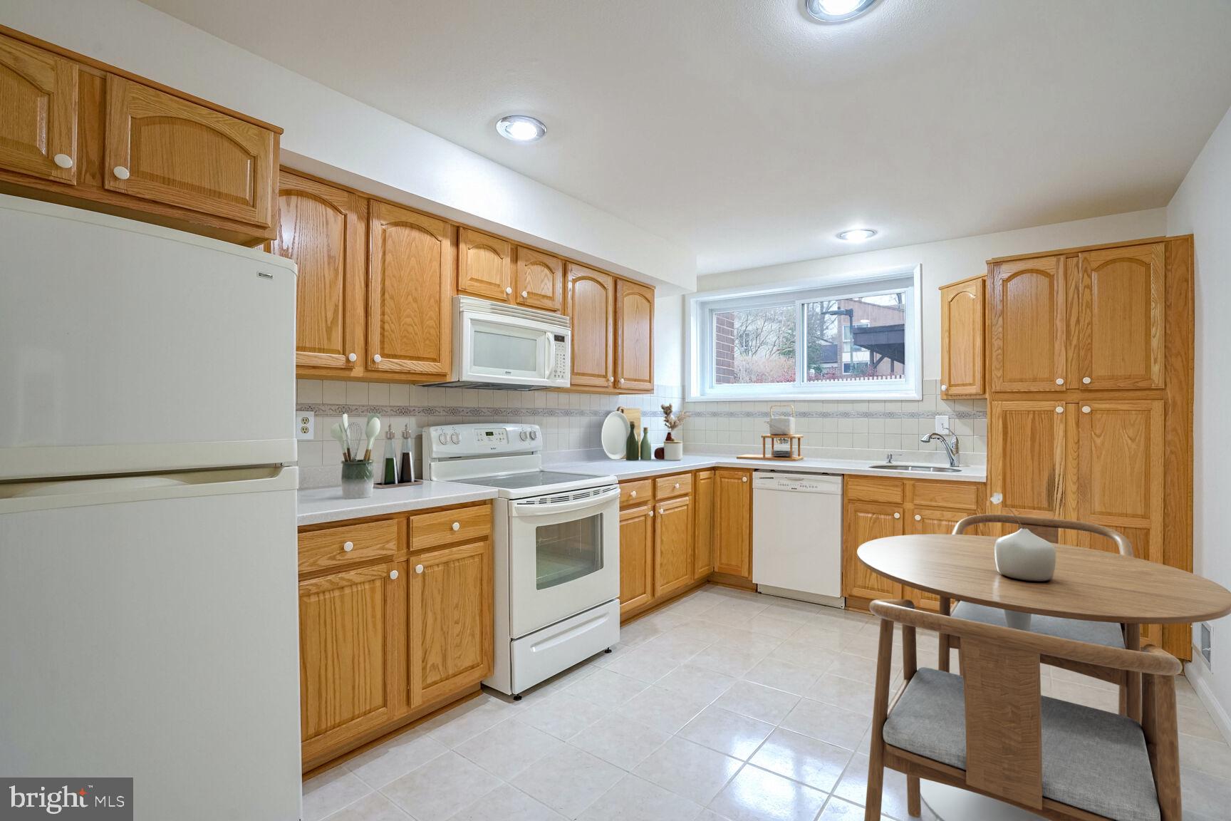 11350 Links Drive Reston, VA 20190 - Photo 8 of 22 a kitchen with a sink a stove a refrigerator cabinets and dining table