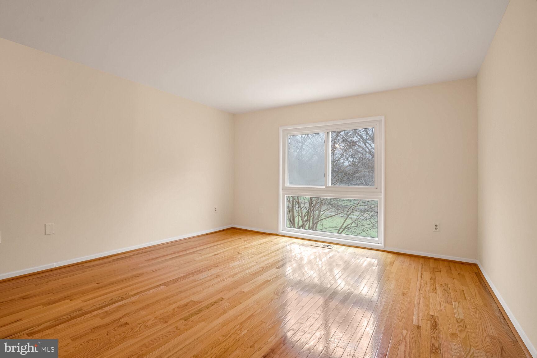 11350 Links Drive Reston, VA 20190 - Photo 10 of 22 an empty room with wooden floor and windows