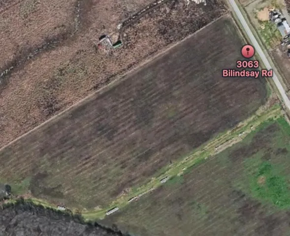 a view of a street with trees in the background