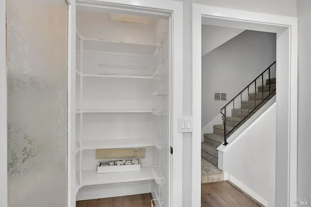 a bathroom with a vase of flowers sink and a mirror