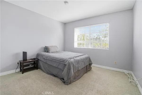 a spacious bedroom with a bed and a window