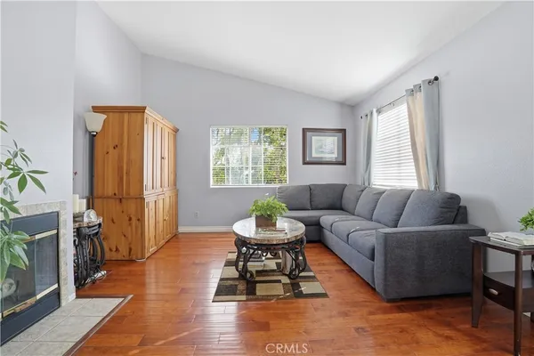 a living room with furniture a window and a flat screen tv