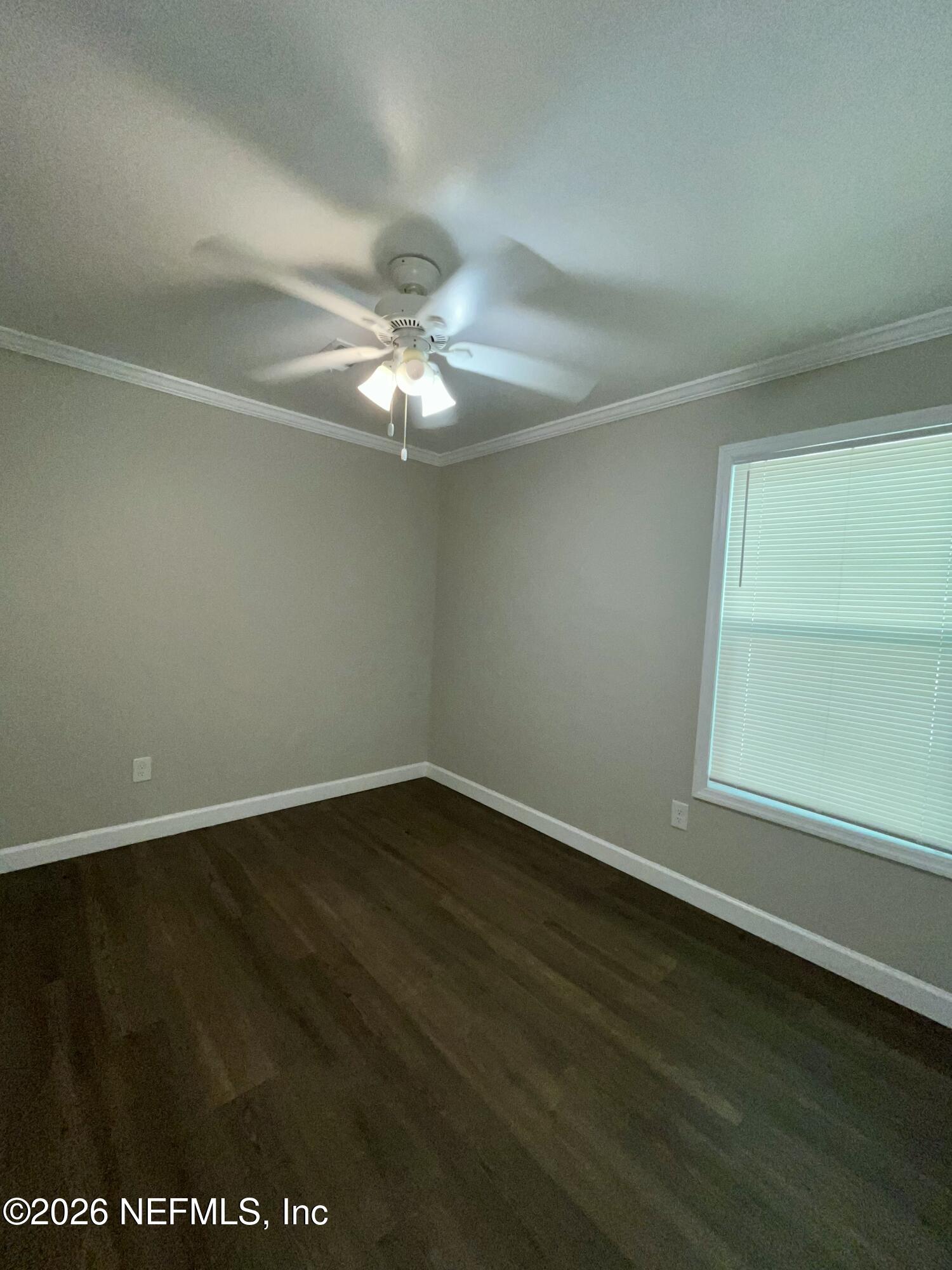 2017 Talladega Road Jacksonville, FL 32209 - Photo 28 of 34 an empty room with wooden floor and windows