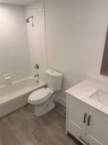 a bathroom with a toilet a sink and bathtub