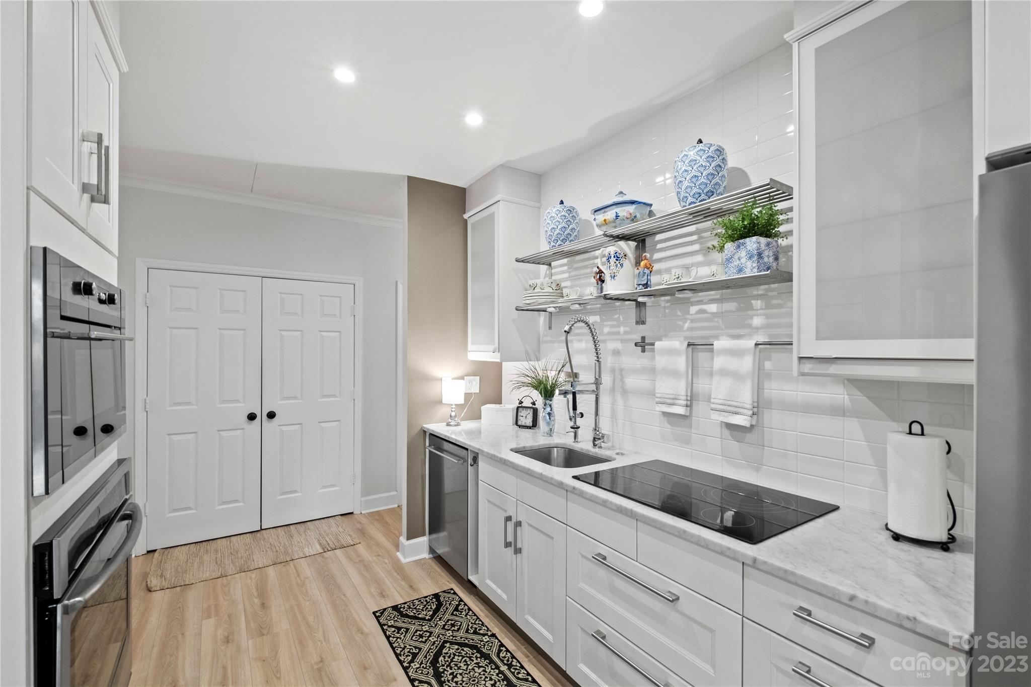 912 Cherokee Road Charlotte, NC 28207 - Photo 16 of 32 a kitchen with stainless steel appliances a sink a refrigerator and cabinets