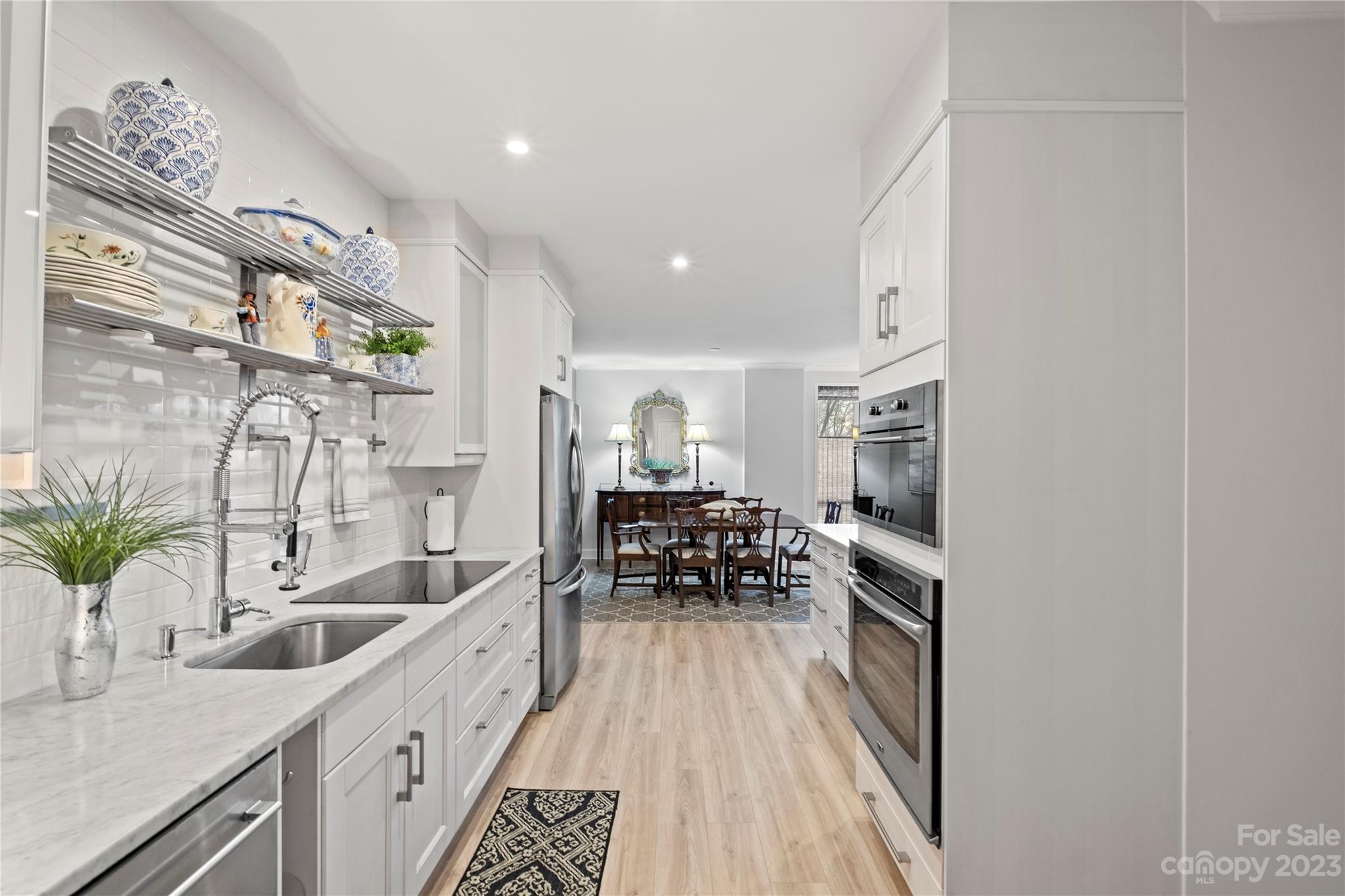 912 Cherokee Road Charlotte, NC 28207 - Photo 18 of 32 a kitchen with granite countertop a sink and a stove top oven