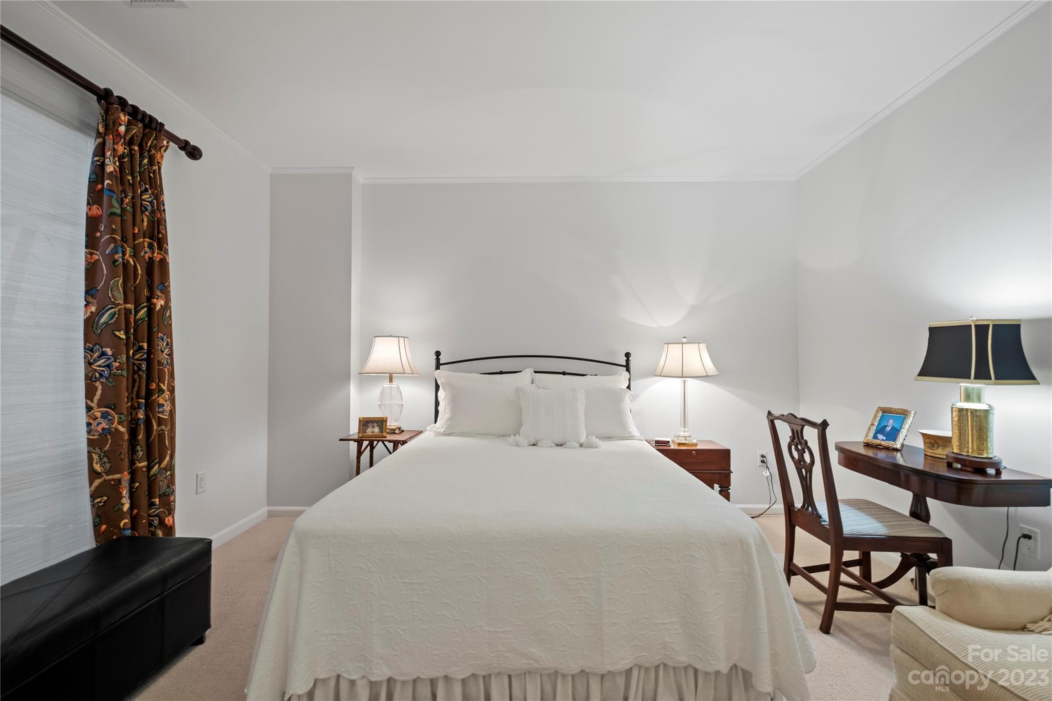 912 Cherokee Road Charlotte, NC 28207 - Photo 22 of 32 a bedroom with a bed and a chair in it