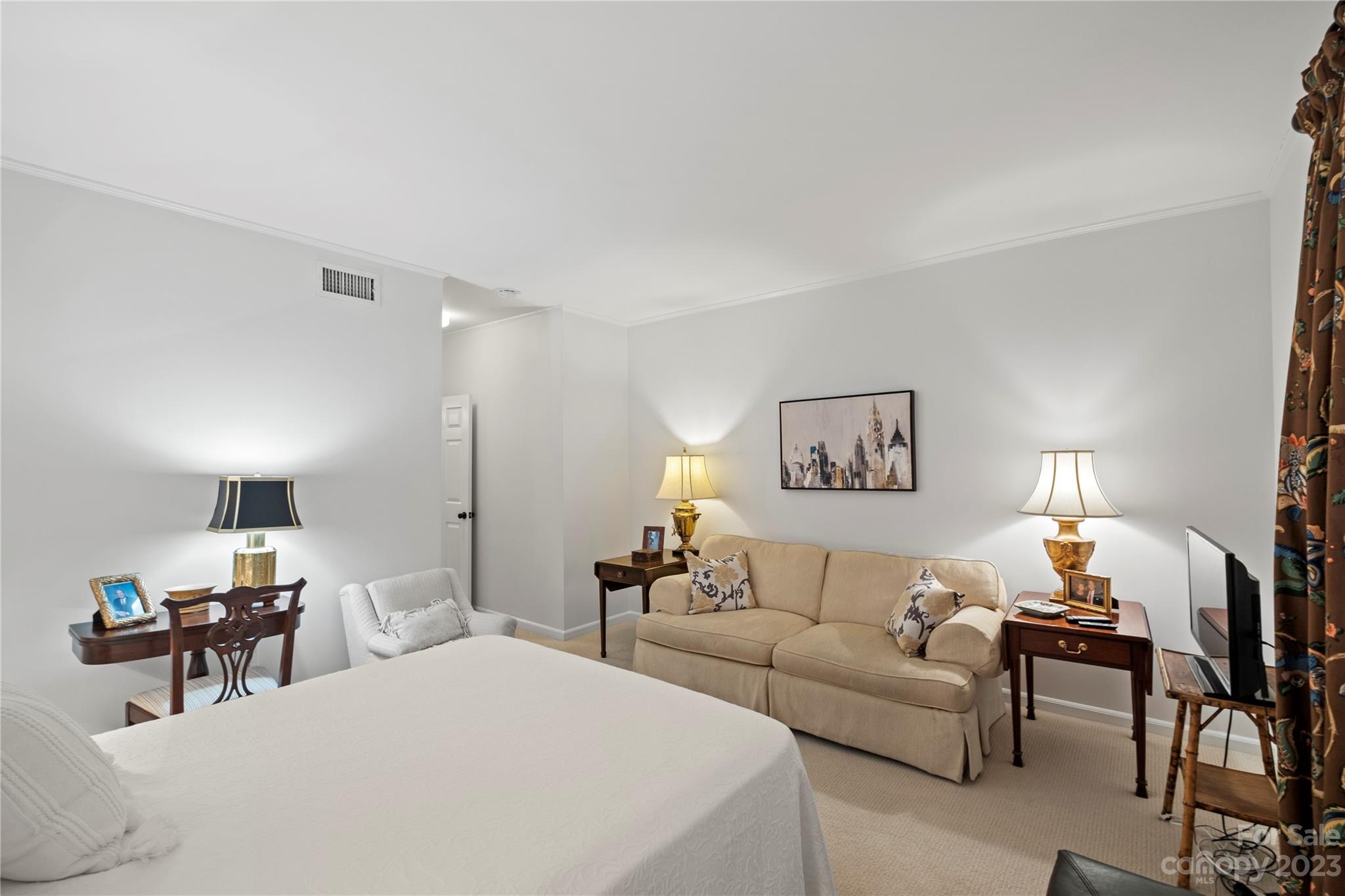 912 Cherokee Road Charlotte, NC 28207 - Photo 23 of 32 a bedroom with furniture and a lamp