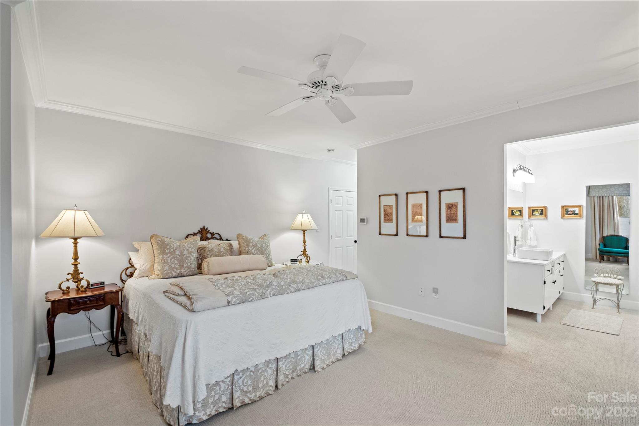 912 Cherokee Road Charlotte, NC 28207 - Photo 26 of 32 a bedroom with a bed and a chandelier