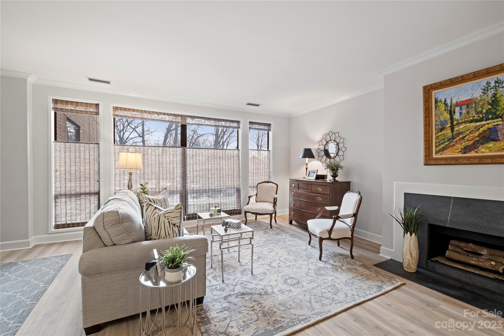 912 Cherokee Road Charlotte, NC 28207 - Photo 10 of 32 a living room with furniture a fireplace and a table