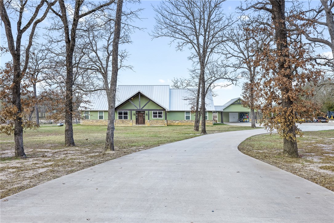 a view of a house with a yard covered in snow