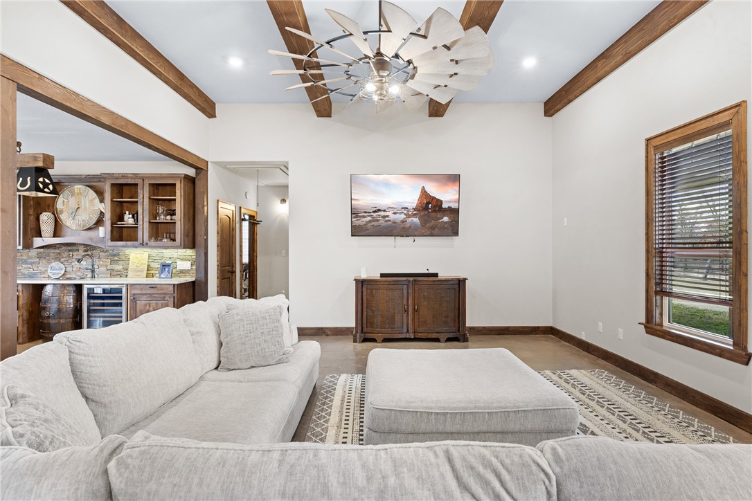 7440 Fm 39 Road South North Zulch, TX 77872 - Photo 14 of 50 a living room with furniture a chandelier and a flat screen tv