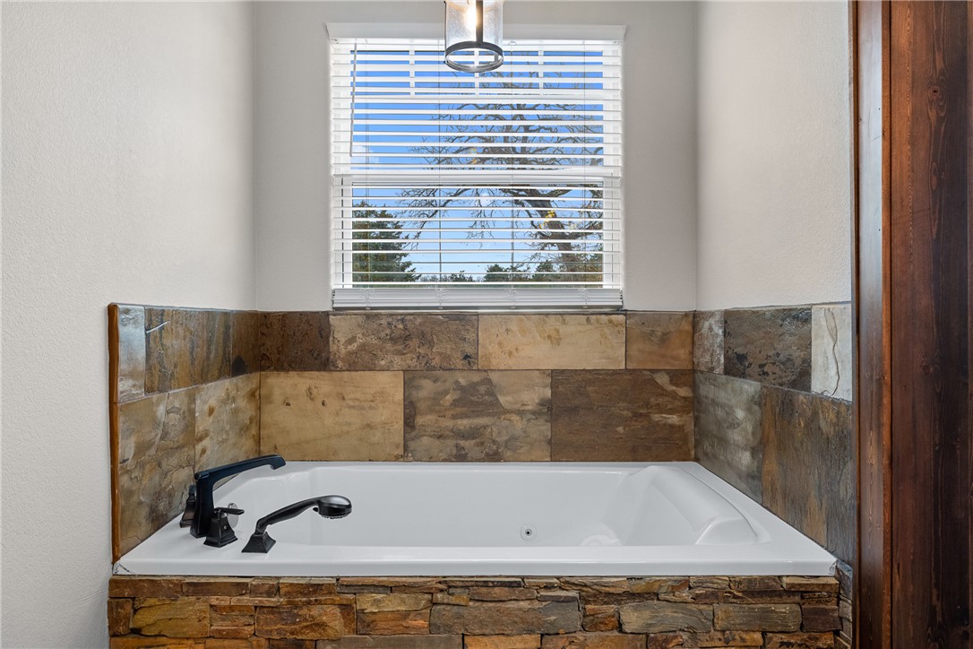 7440 Fm 39 Road South North Zulch, TX 77872 - Photo 24 of 50 a bathroom with a bathtub