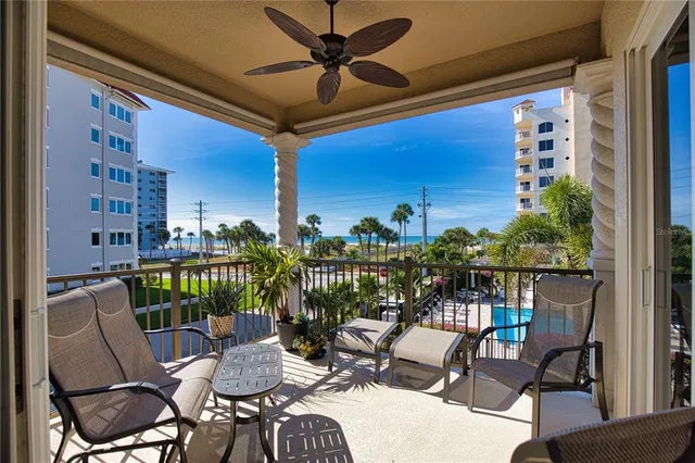 a view of a balcony with chairs and a potted plant