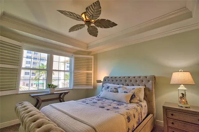a bedroom with a large bed and a chandelier