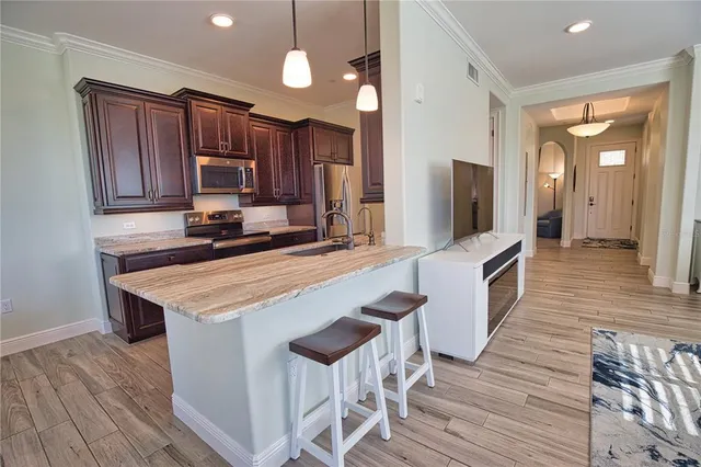 a kitchen with wooden cabinets and stainless steel appliances