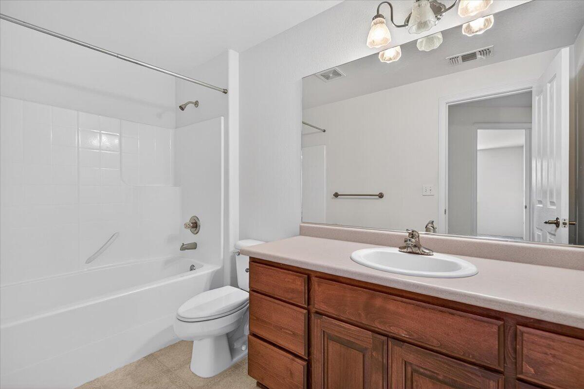 2618 Rabun Way Central Point, OR 97502 - Photo 31 of 42 a bathroom with a sink a toilet a mirror a bathtub and shower