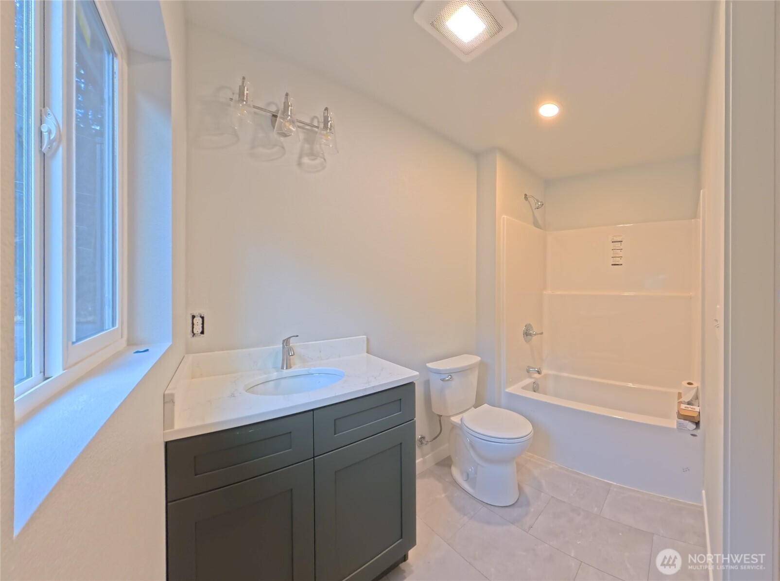 2923 Brook Lane Sedro-Woolley, WA 98284 - Photo 8 of 10 a bathroom with a sink a toilet a large mirror and vanity
