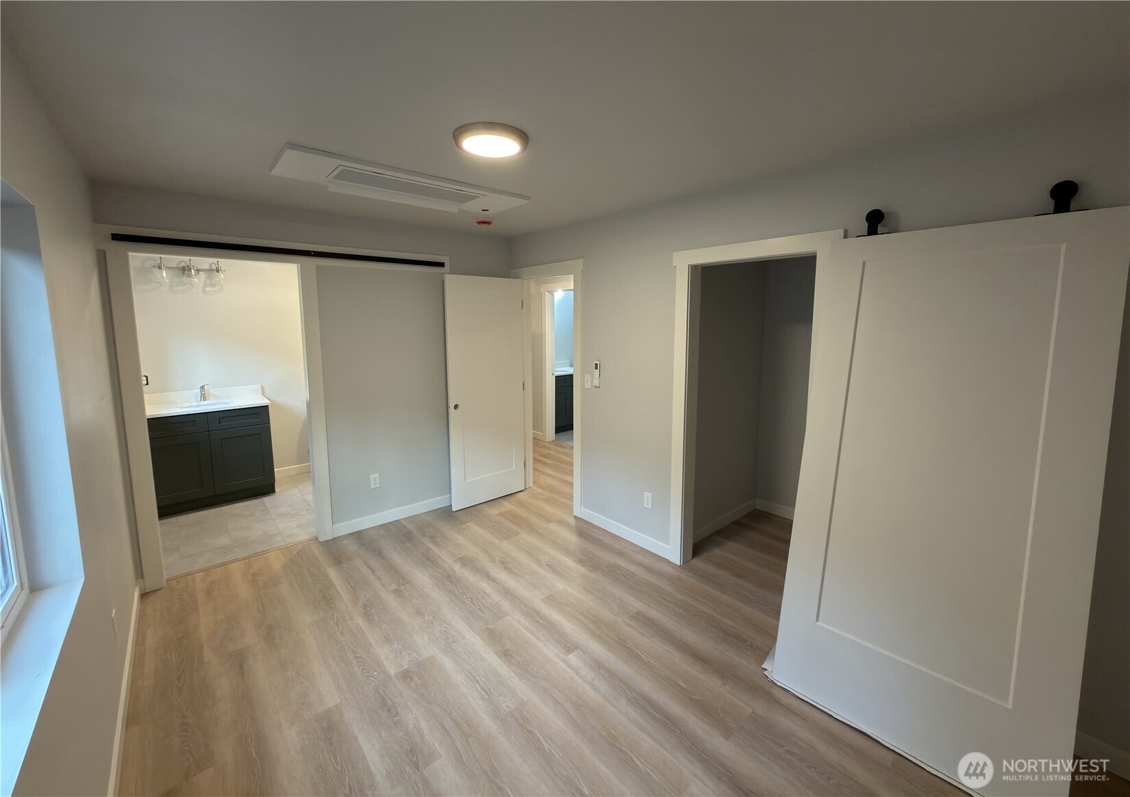 2923 Brook Lane Sedro-Woolley, WA 98284 - Photo 10 of 10 a view of an empty room with wooden floor and a cabinet