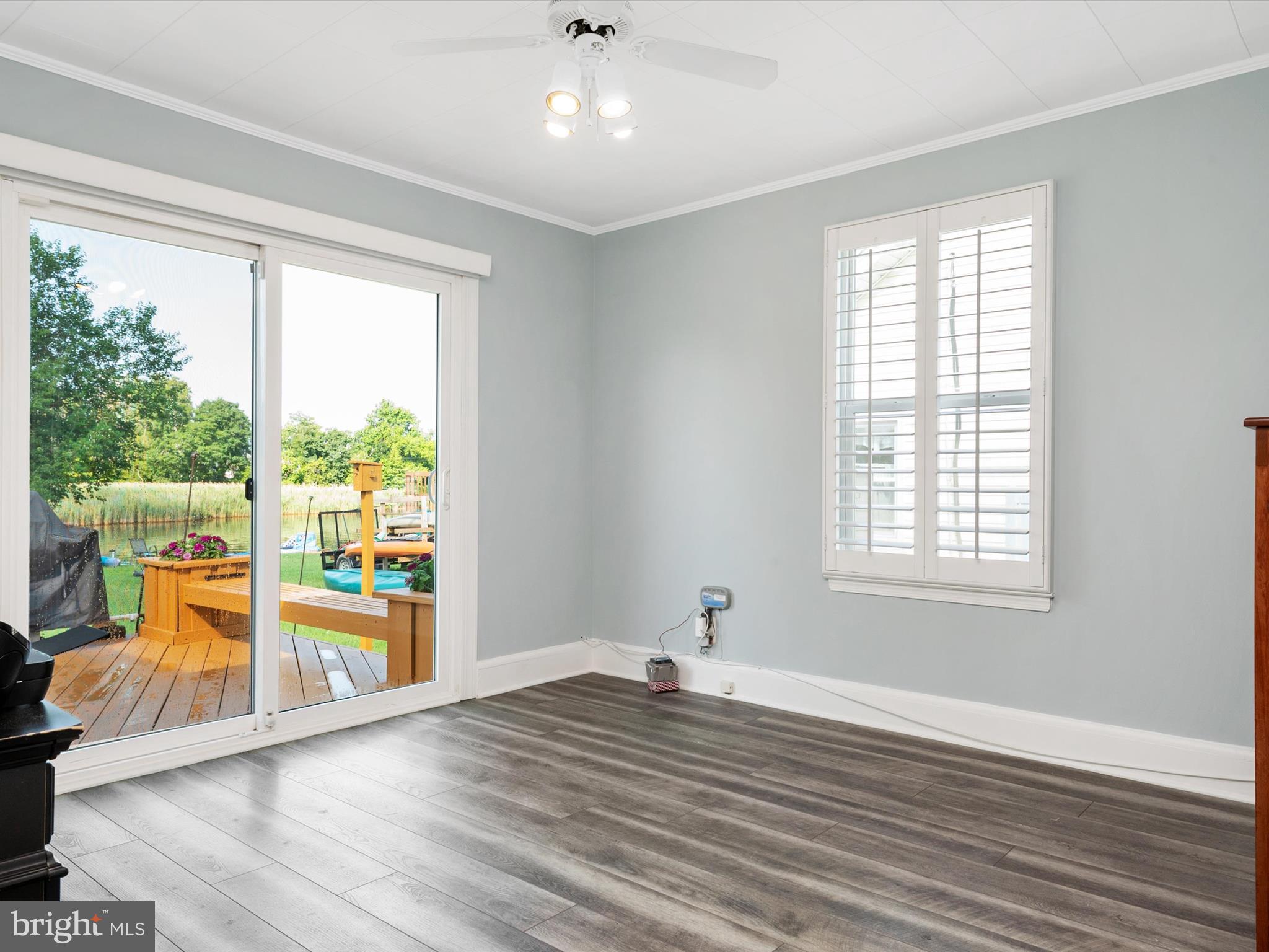8426 Park Road Pasadena, MD 21122 - Photo 16 of 59 an empty room with wooden floor and windows