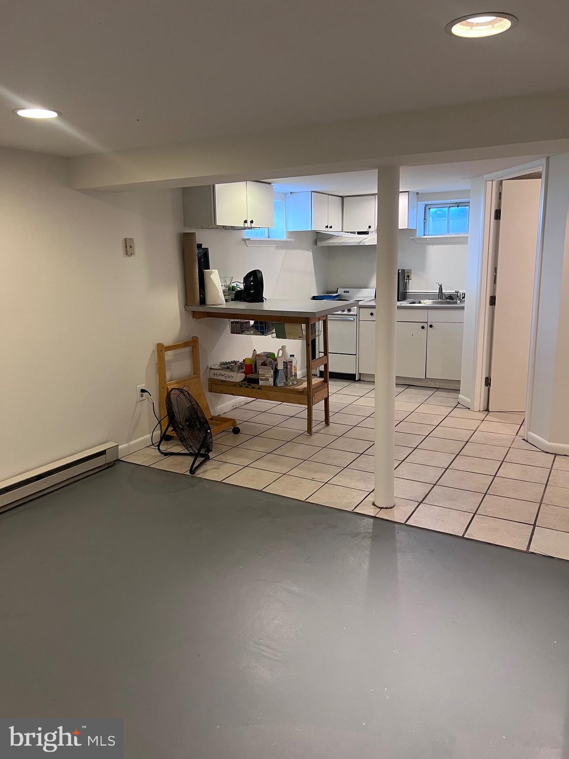 8426 Park Road Pasadena, MD 21122 - Photo 32 of 59 a living room with furniture and a refrigerator