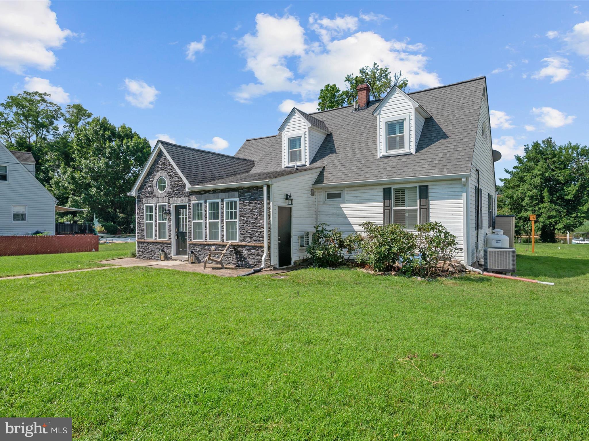 8426 Park Road Pasadena, MD 21122 - Photo 39 of 59 a front view of a house with swimming pool having outdoor seating