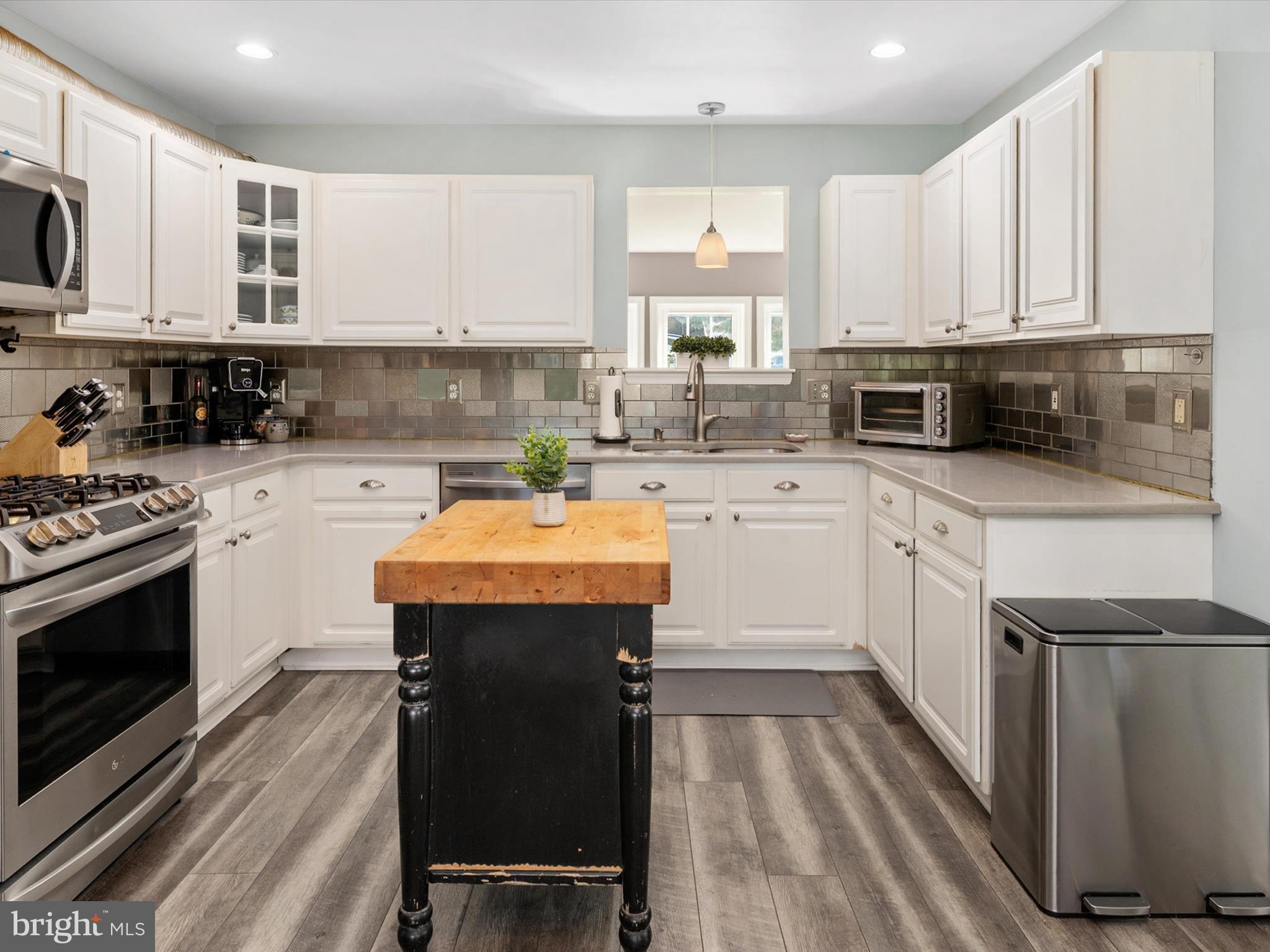 8426 Park Road Pasadena, MD 21122 - Photo 5 of 59 a kitchen with a sink a stove a microwave and cabinets