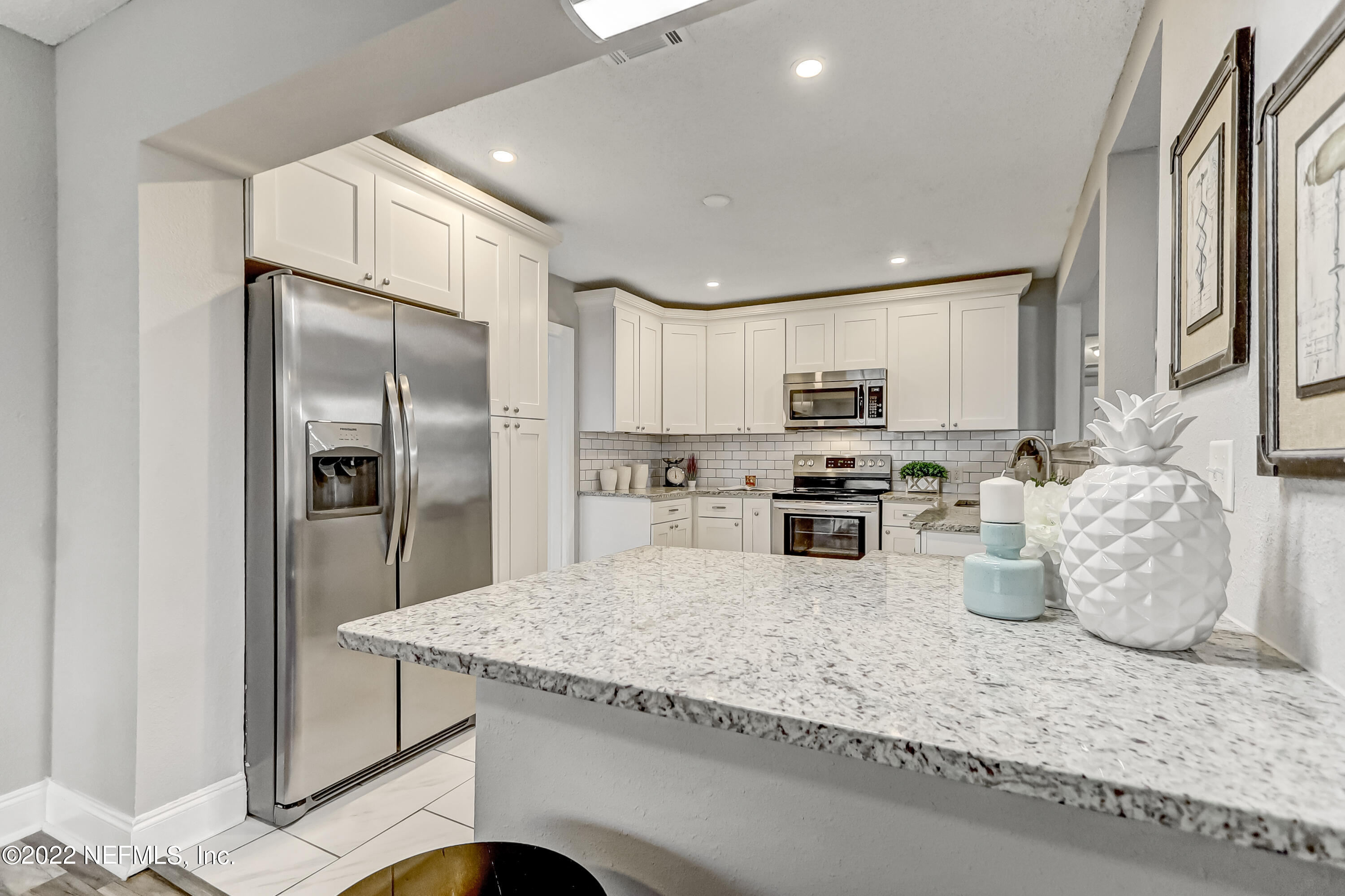 3607 Basil Road Jacksonville, FL 32207 - Photo 12 of 31 a kitchen with stainless steel appliances granite countertop a refrigerator a stove and a sink