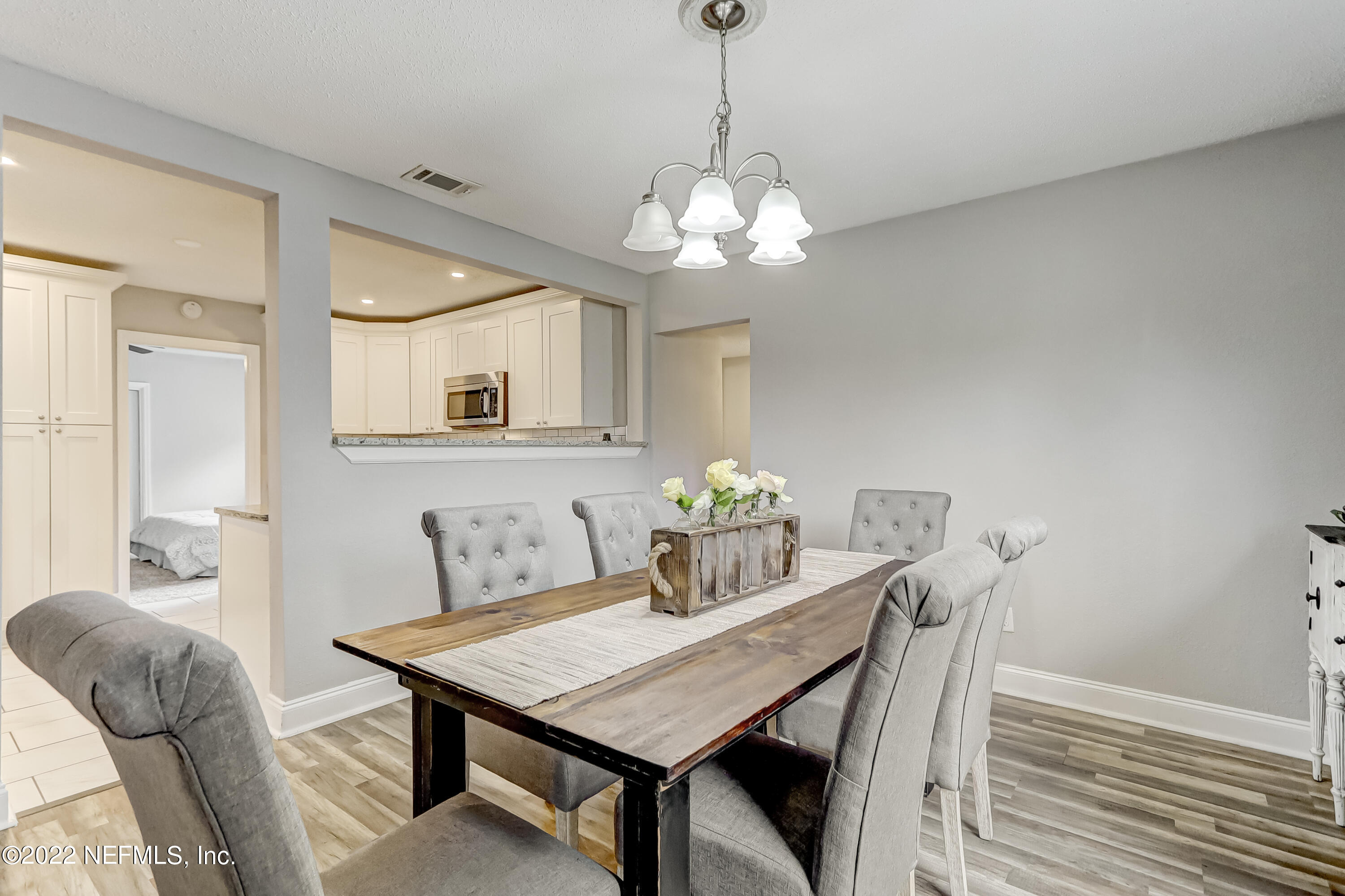 3607 Basil Road Jacksonville, FL 32207 - Photo 17 of 31 a view of a dining room with furniture and chandelier