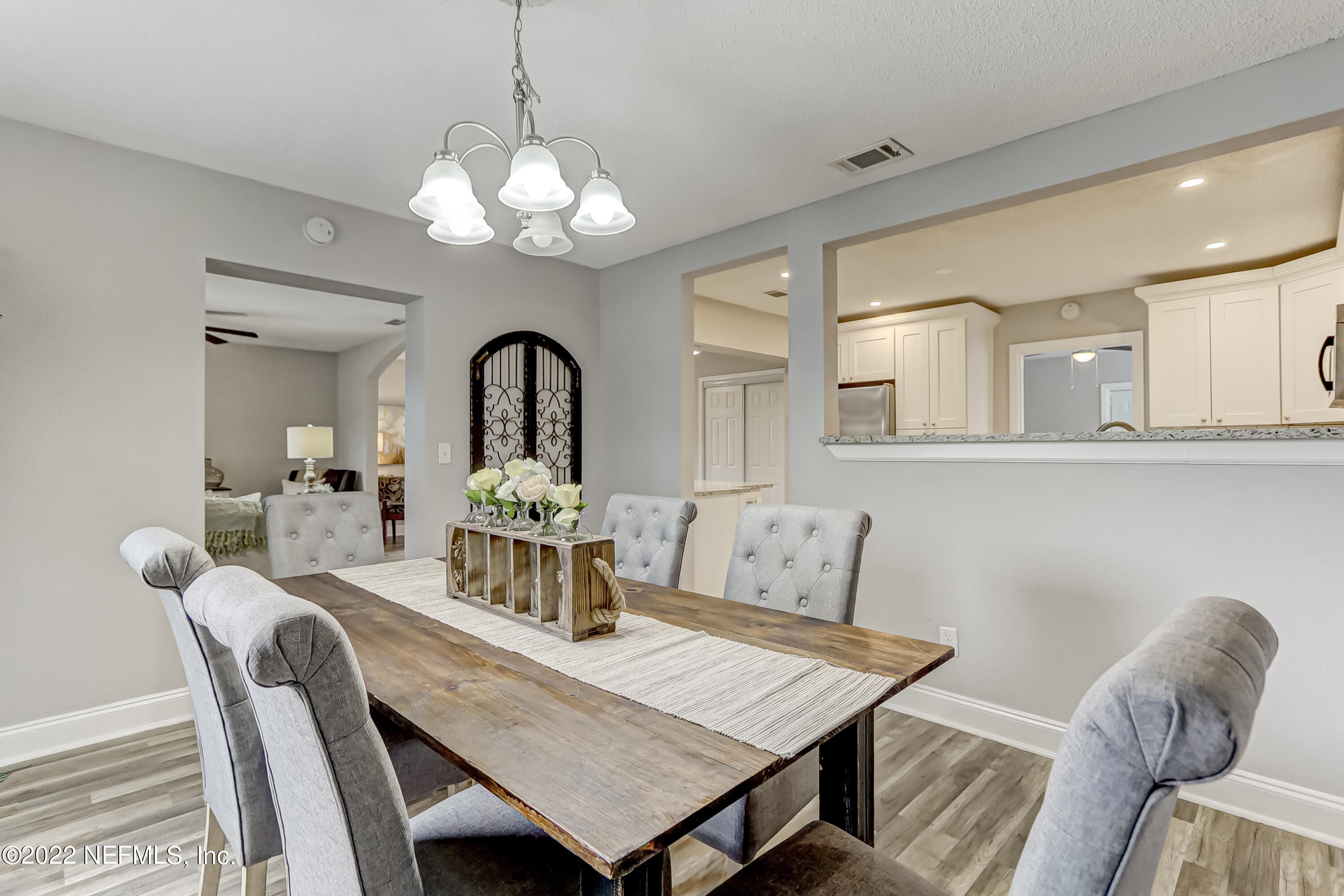 3607 Basil Road Jacksonville, FL 32207 - Photo 18 of 31 a view of a dining room with furniture and chandelier
