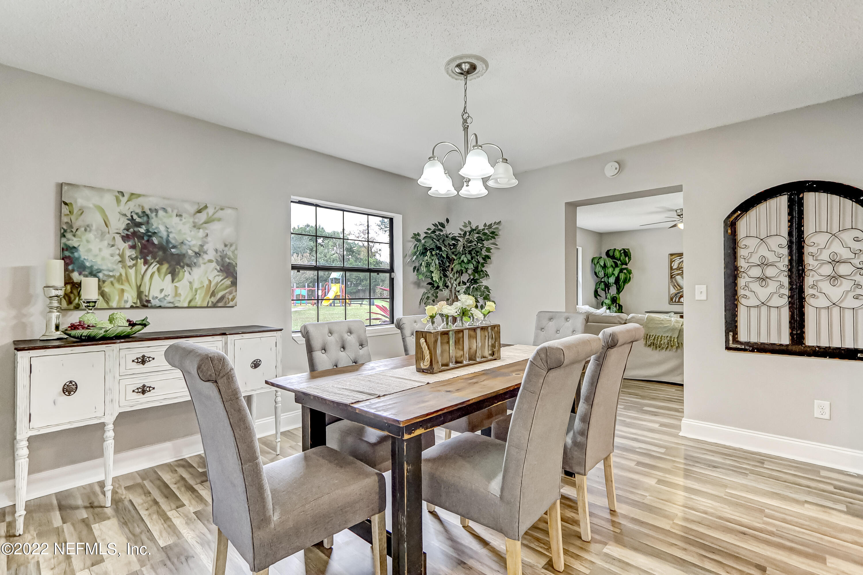 3607 Basil Road Jacksonville, FL 32207 - Photo 19 of 31 a view of a dining room with furniture a chandelier and wooden floor