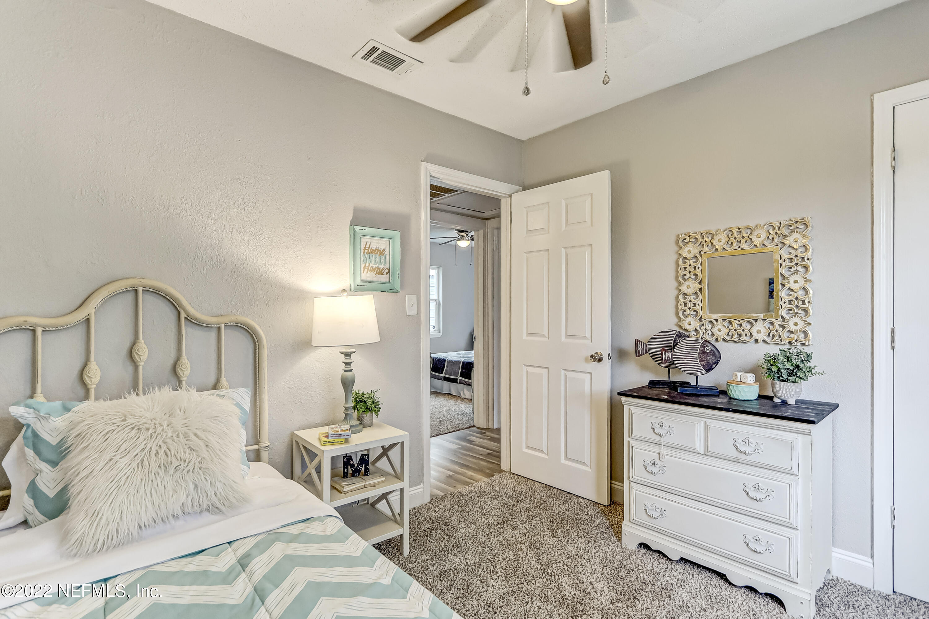 3607 Basil Road Jacksonville, FL 32207 - Photo 21 of 31 a bedroom with a bed and a dresser in it