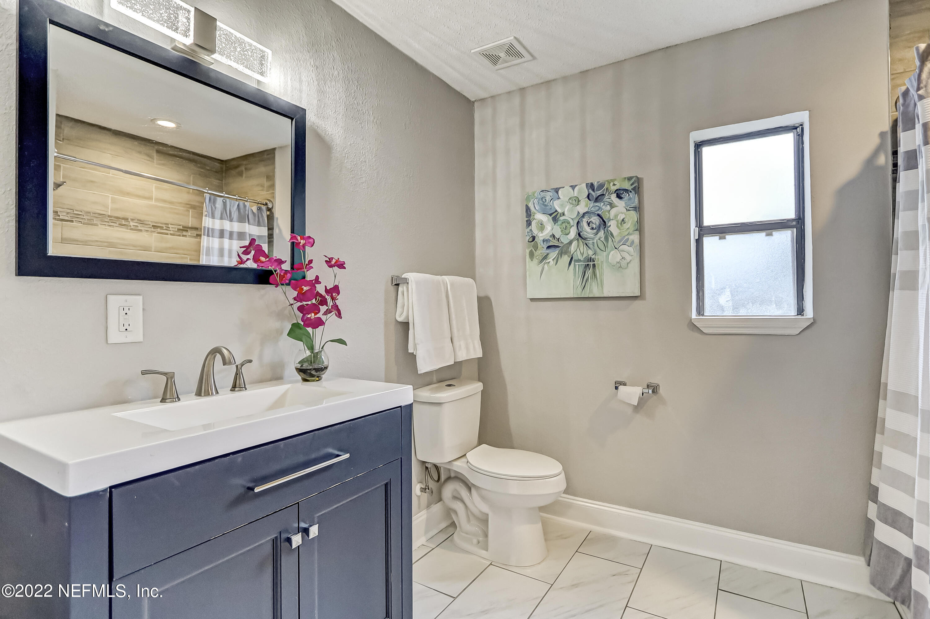 3607 Basil Road Jacksonville, FL 32207 - Photo 26 of 31 a bathroom with a sink mirror and toilet