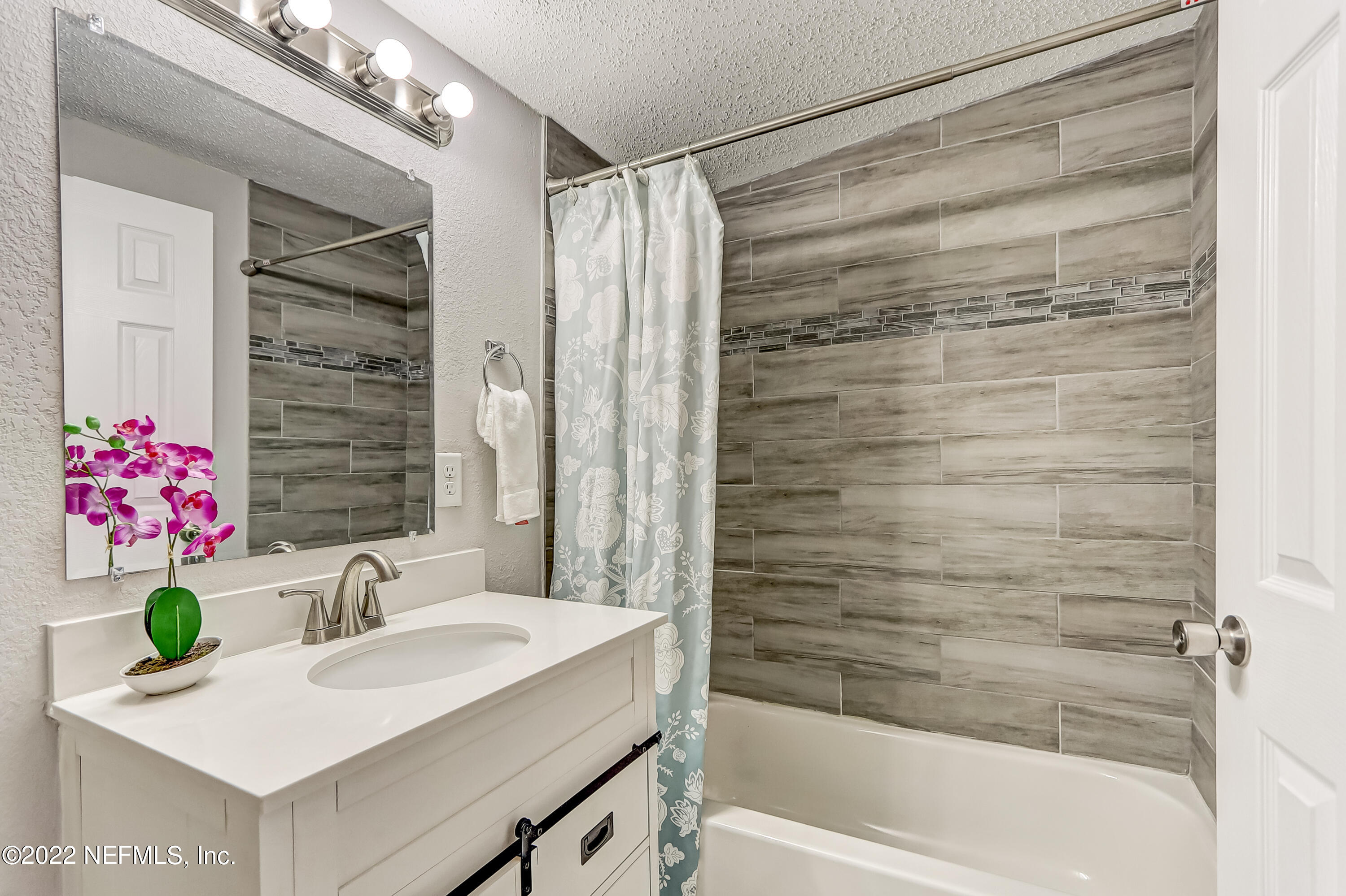 3607 Basil Road Jacksonville, FL 32207 - Photo 30 of 31 a bathroom with a sink and a bathtub