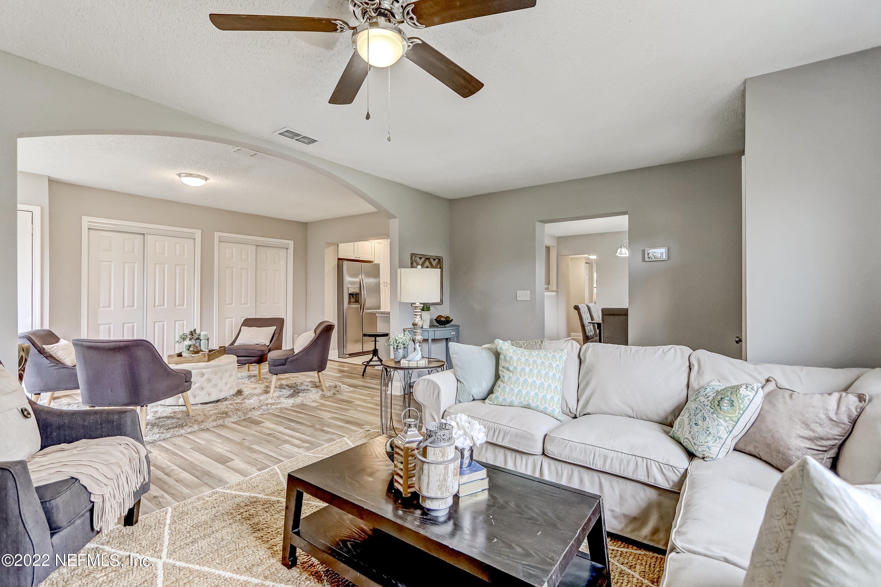3607 Basil Road Jacksonville, FL 32207 - Photo 6 of 31 a living room with furniture and a chandelier