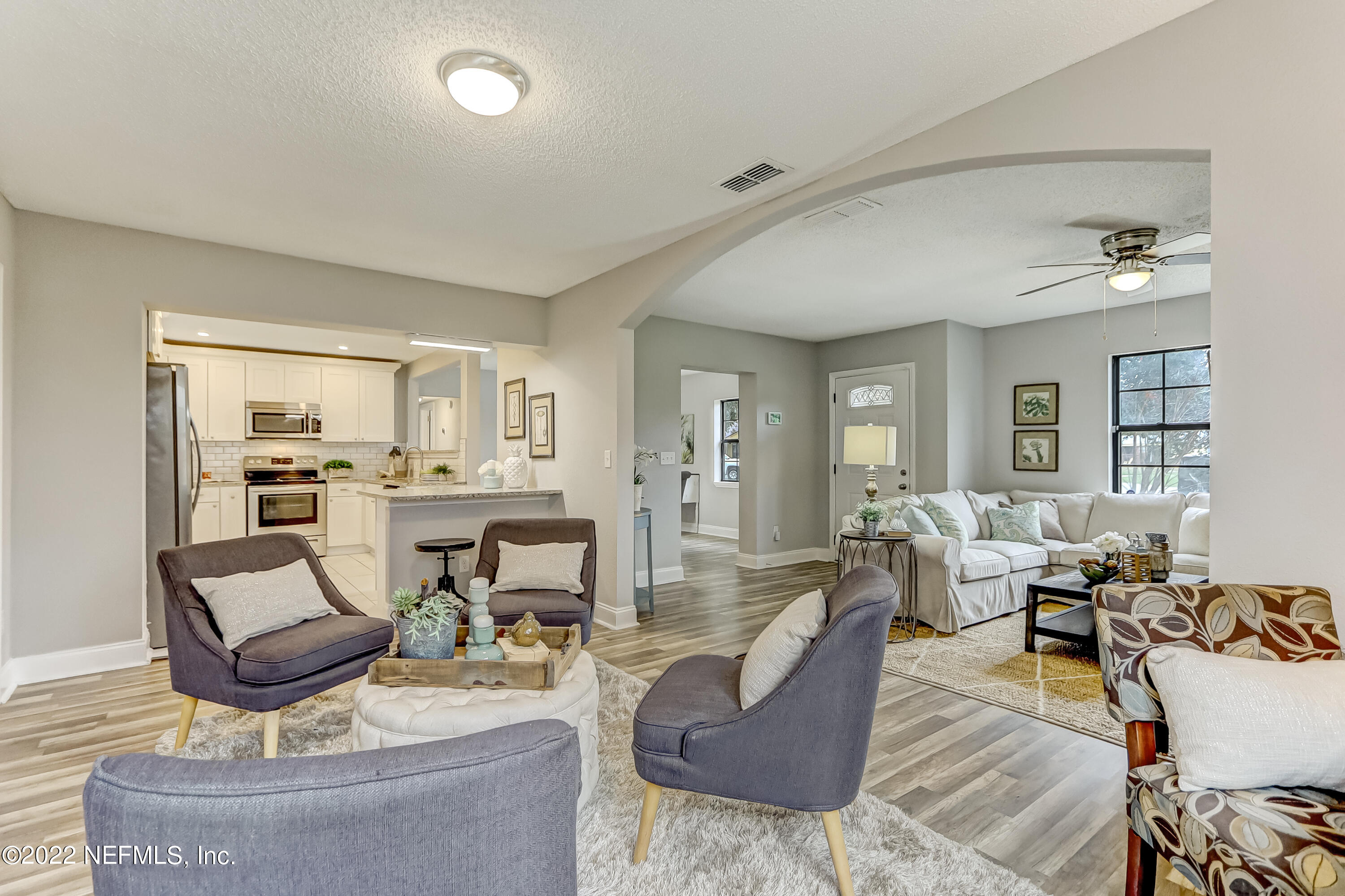 3607 Basil Road Jacksonville, FL 32207 - Photo 8 of 31 a living room with fireplace furniture and a view of kitchen
