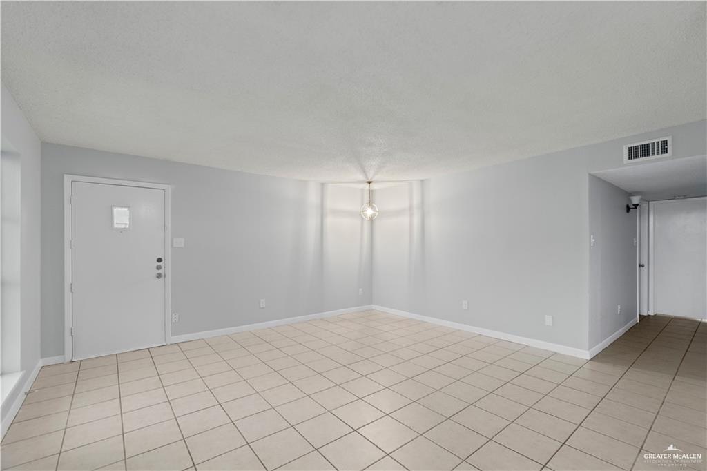 1701 West McIntyre Street, Unit 5 Edinburg, TX 78542 - Photo 7 of 15 Spare room with light tile patterned floors and a textured ceiling