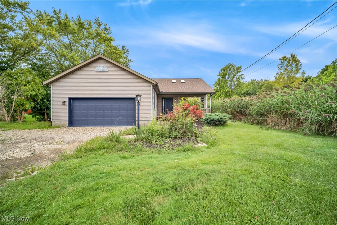 6818 Warner Road Madison, OH 44057 - Photo 2 of 29 Ranch-style house featuring a garage and a front lawn
