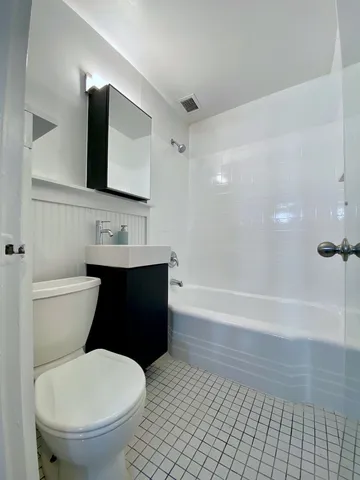 a bathroom with a toilet a sink and bathtub