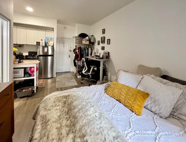 a bedroom with bed and a closet