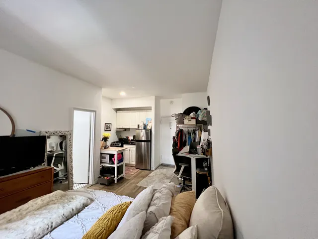 a view of a livingroom with furniture and a flat screen tv