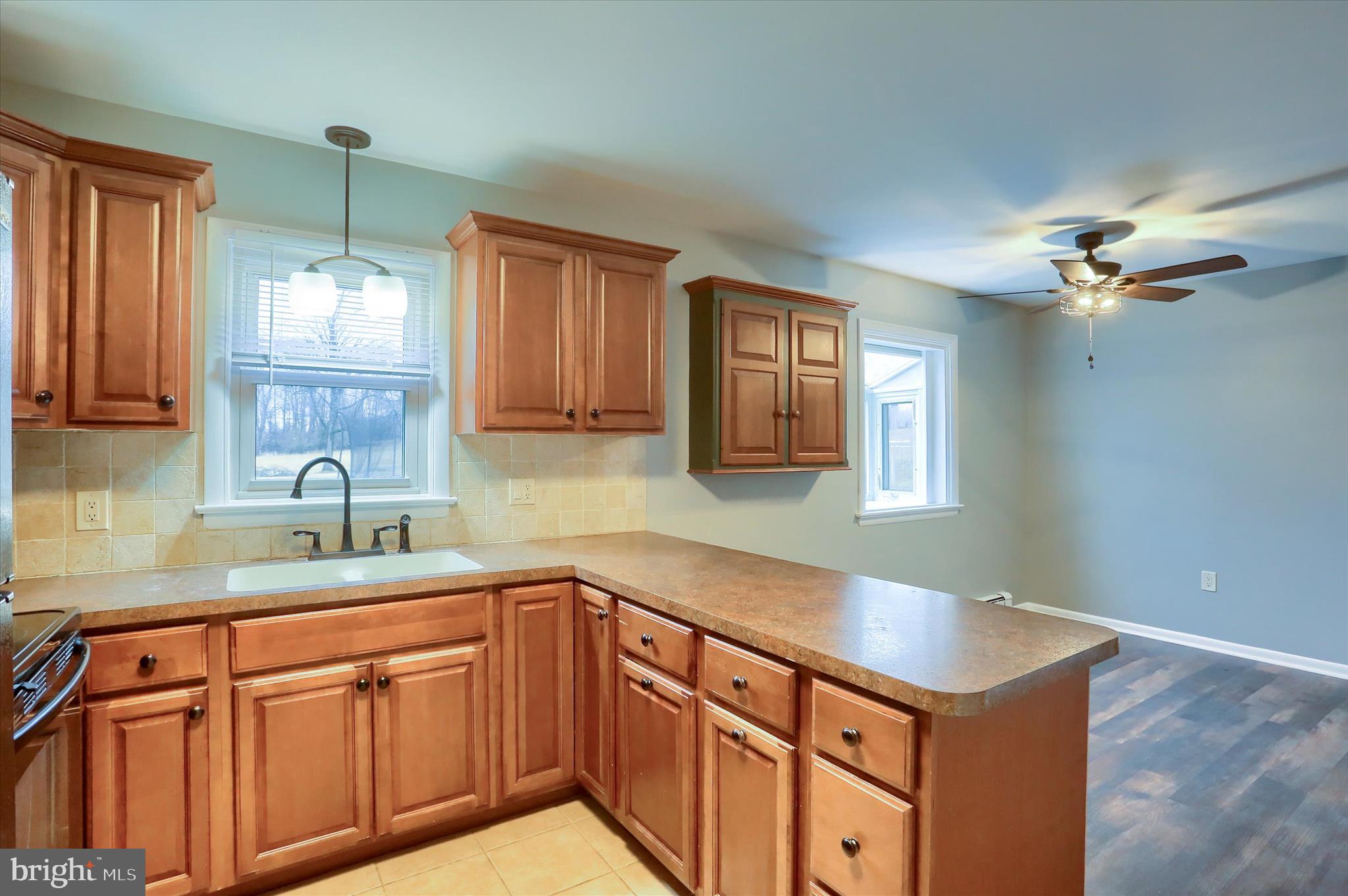 685 Knight Road Harrisburg, PA 17111 - Photo 12 of 47 a kitchen with a sink dishwasher a stove and white cabinets with wooden floor