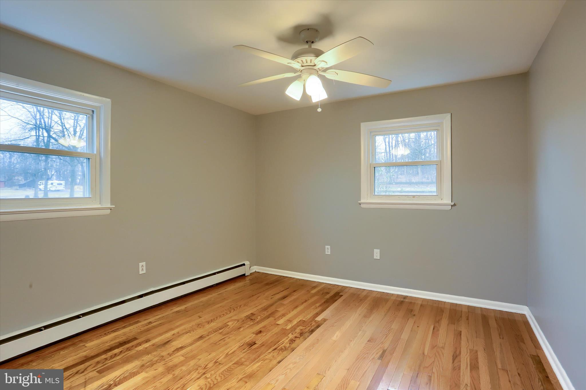 685 Knight Road Harrisburg, PA 17111 - Photo 18 of 47 a view of an empty room with wooden floor and a window