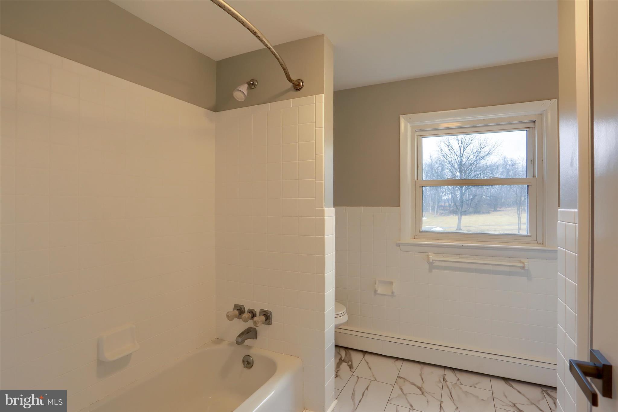 685 Knight Road Harrisburg, PA 17111 - Photo 30 of 47 a bathroom with a tub and a window