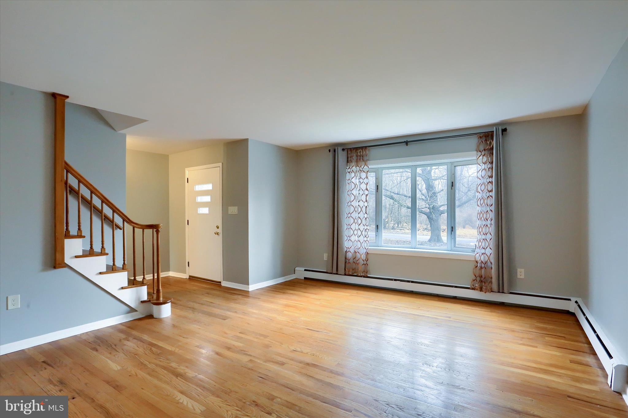 685 Knight Road Harrisburg, PA 17111 - Photo 8 of 47 a view of an empty room with glass door and wooden floor