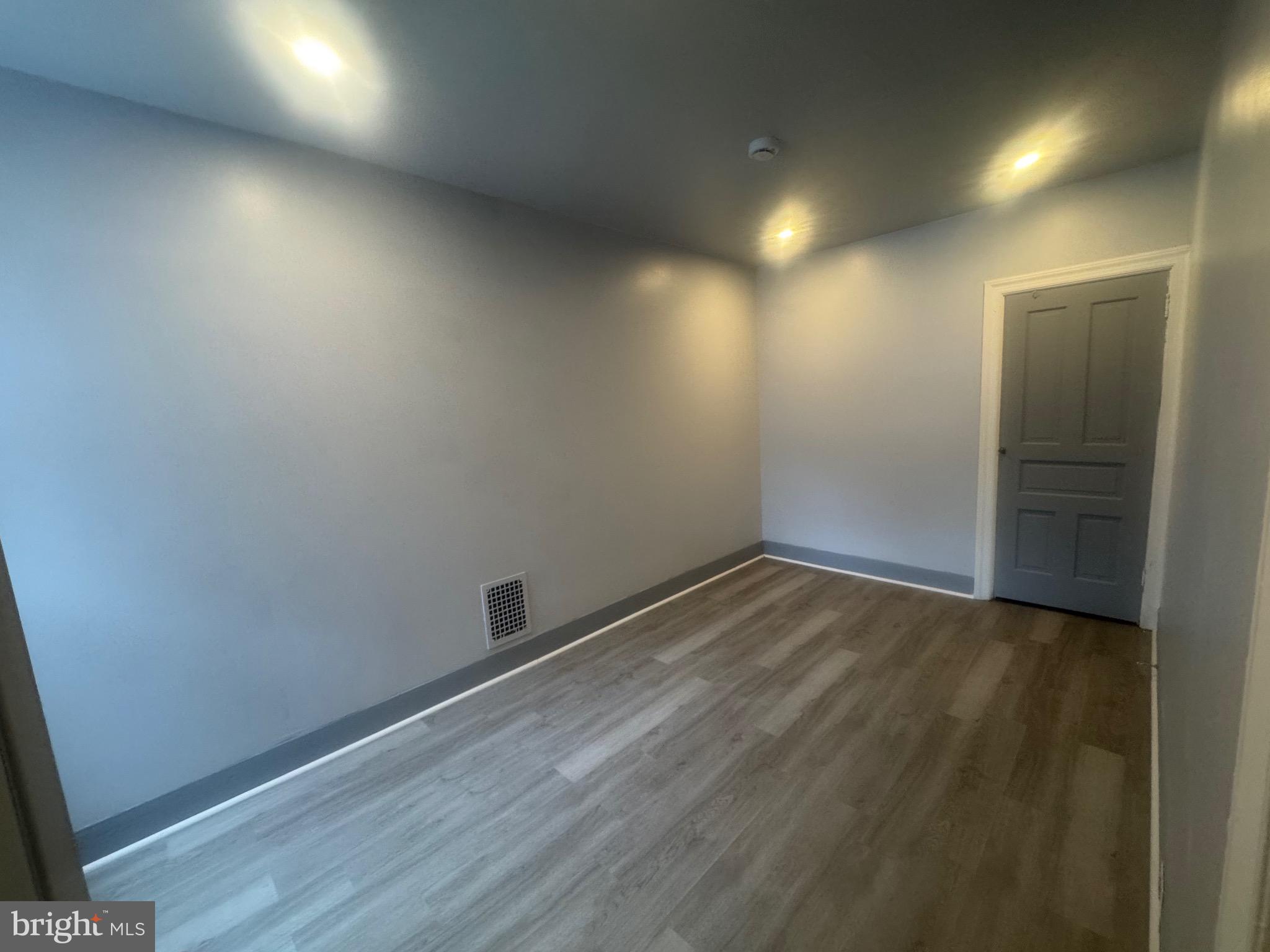 3003 Washington Street Wilmington, DE 19802 - Photo 12 of 18 an empty room with wooden floor and windows