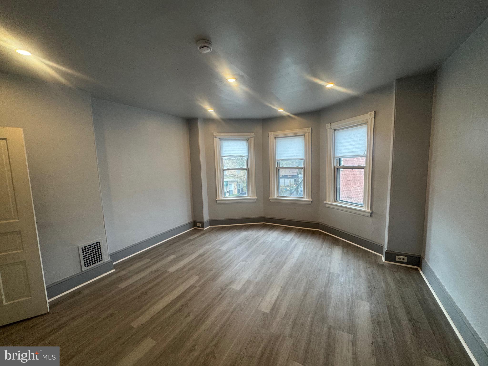 3003 Washington Street Wilmington, DE 19802 - Photo 9 of 18 an empty room with wooden floor and windows